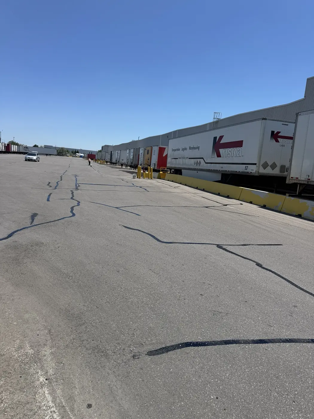 Completed crack sealing across a large industrial loading area