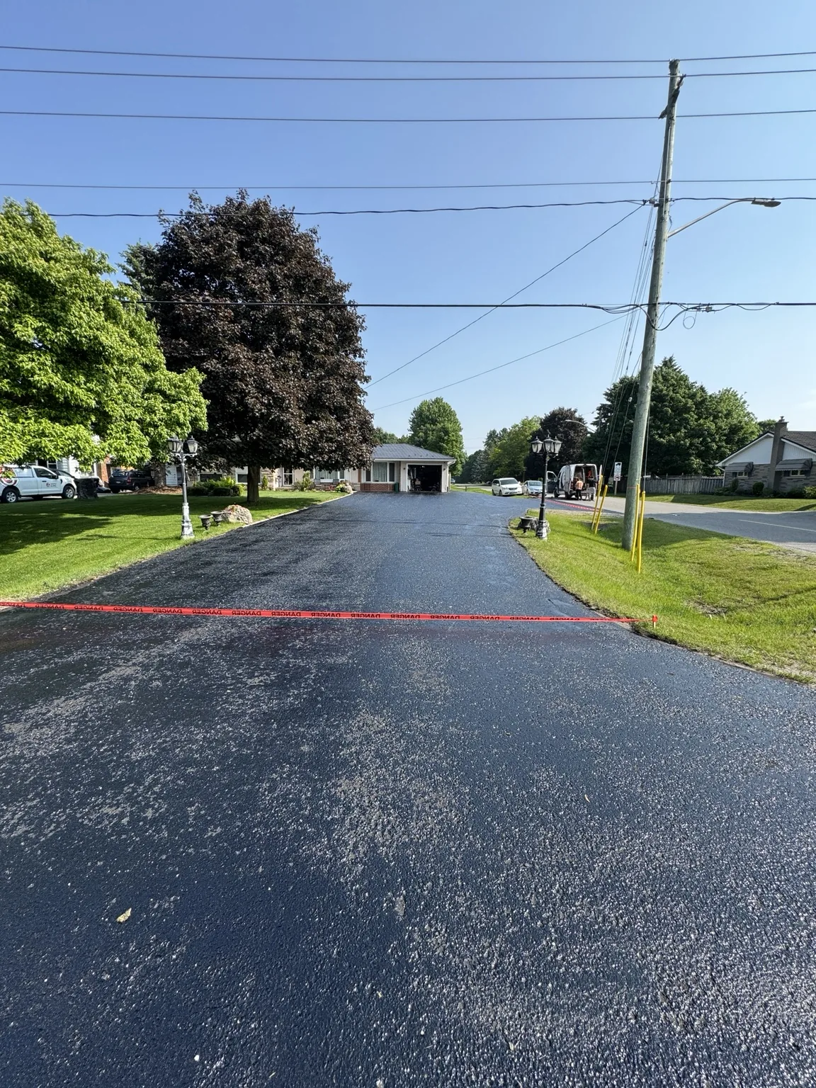 Freshly sealed large asphalt driveway