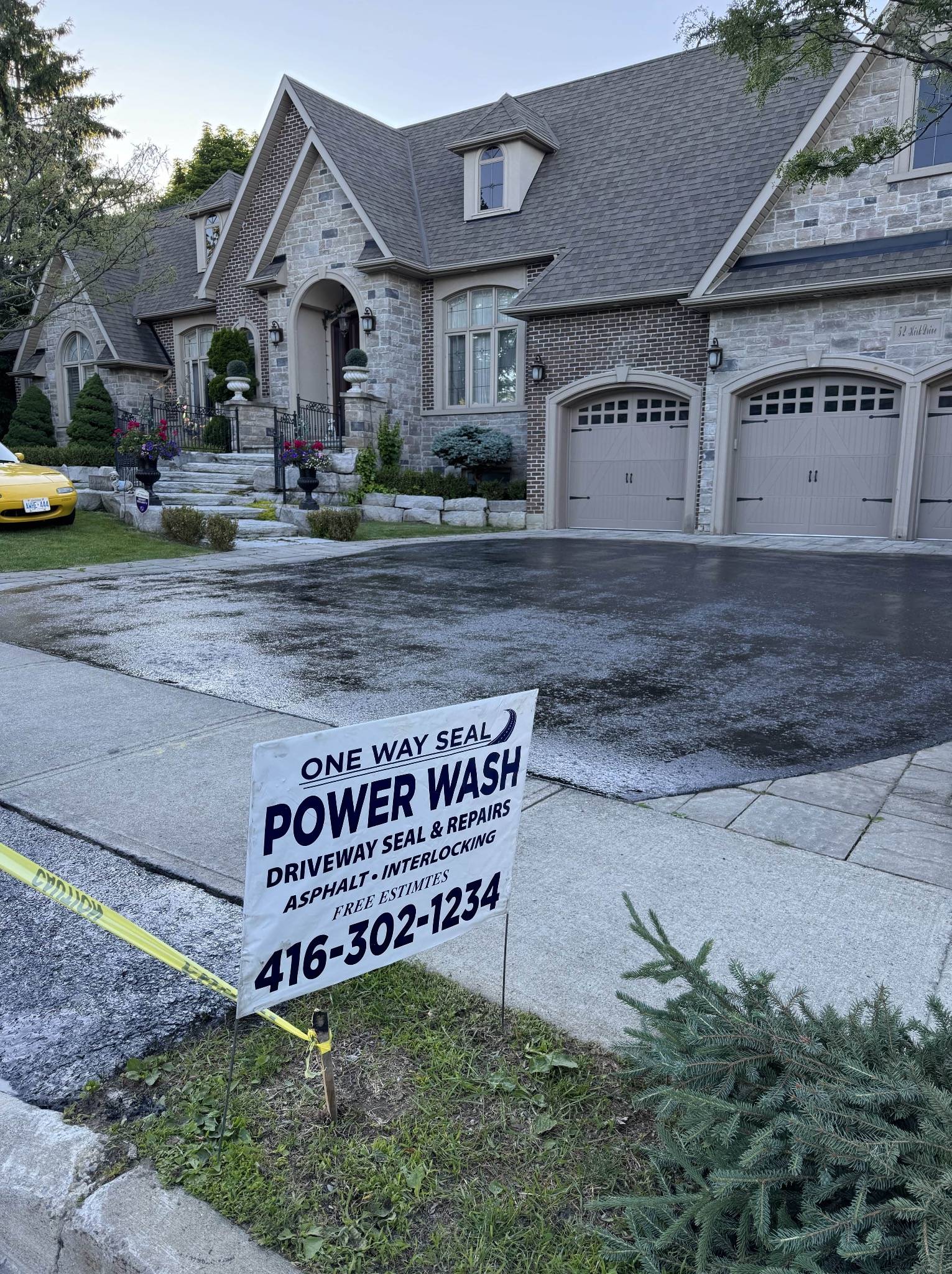 Clean sealed asphalt driveway improving curb appeal