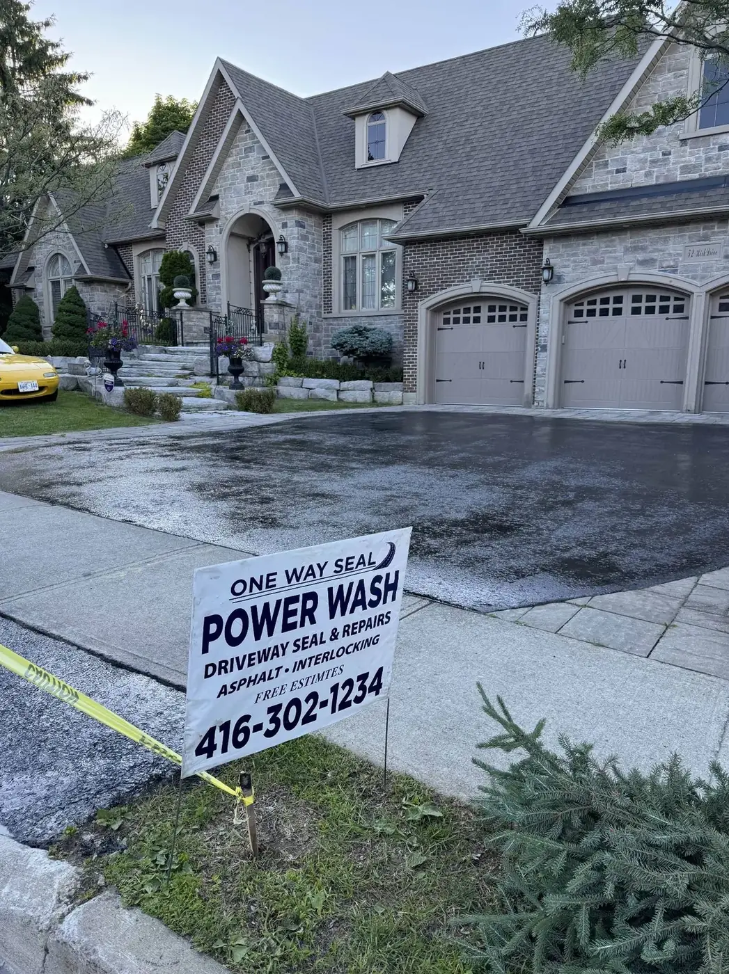 Clean sealed asphalt driveway improving curb appeal