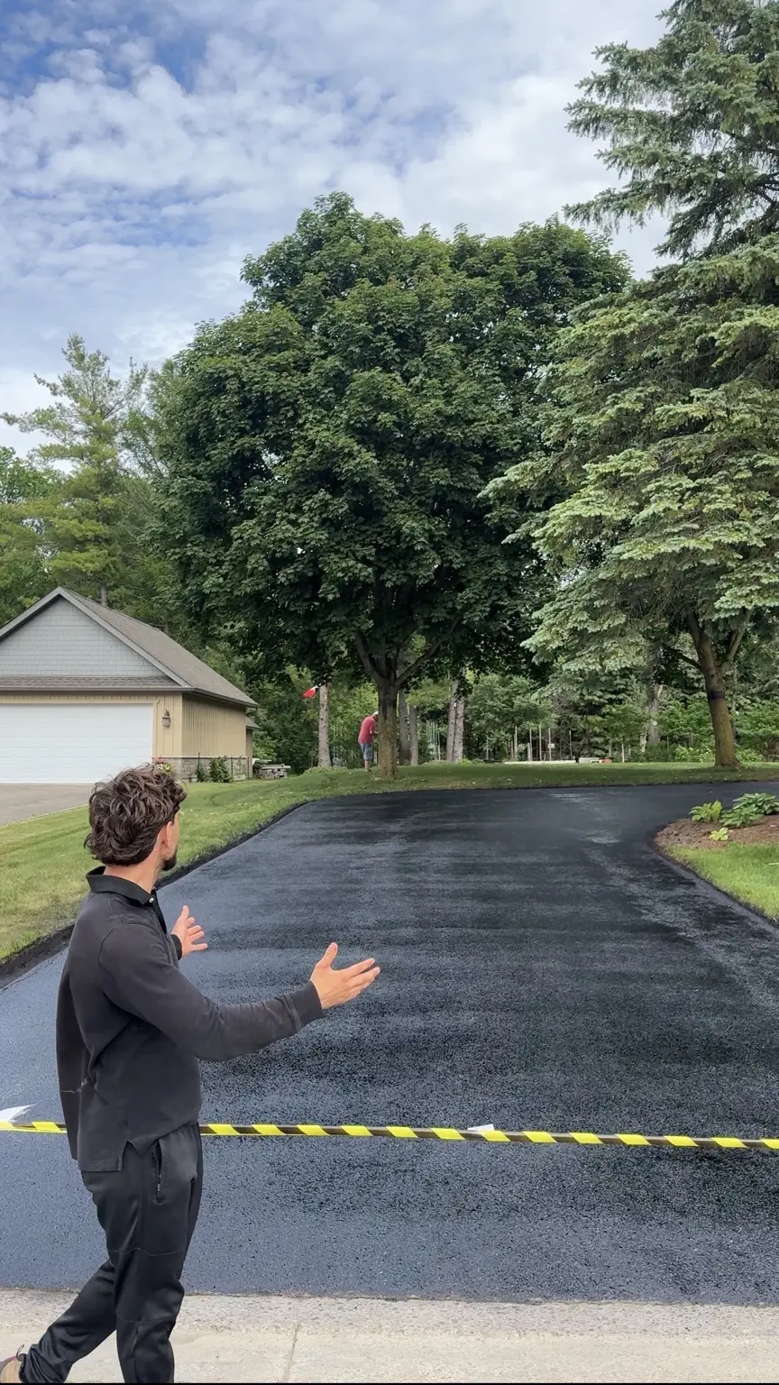 Oneway team member presenting a freshly sealed driveway