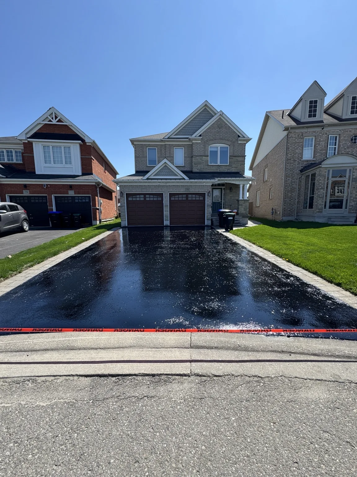 Freshly sealed large asphalt driveway