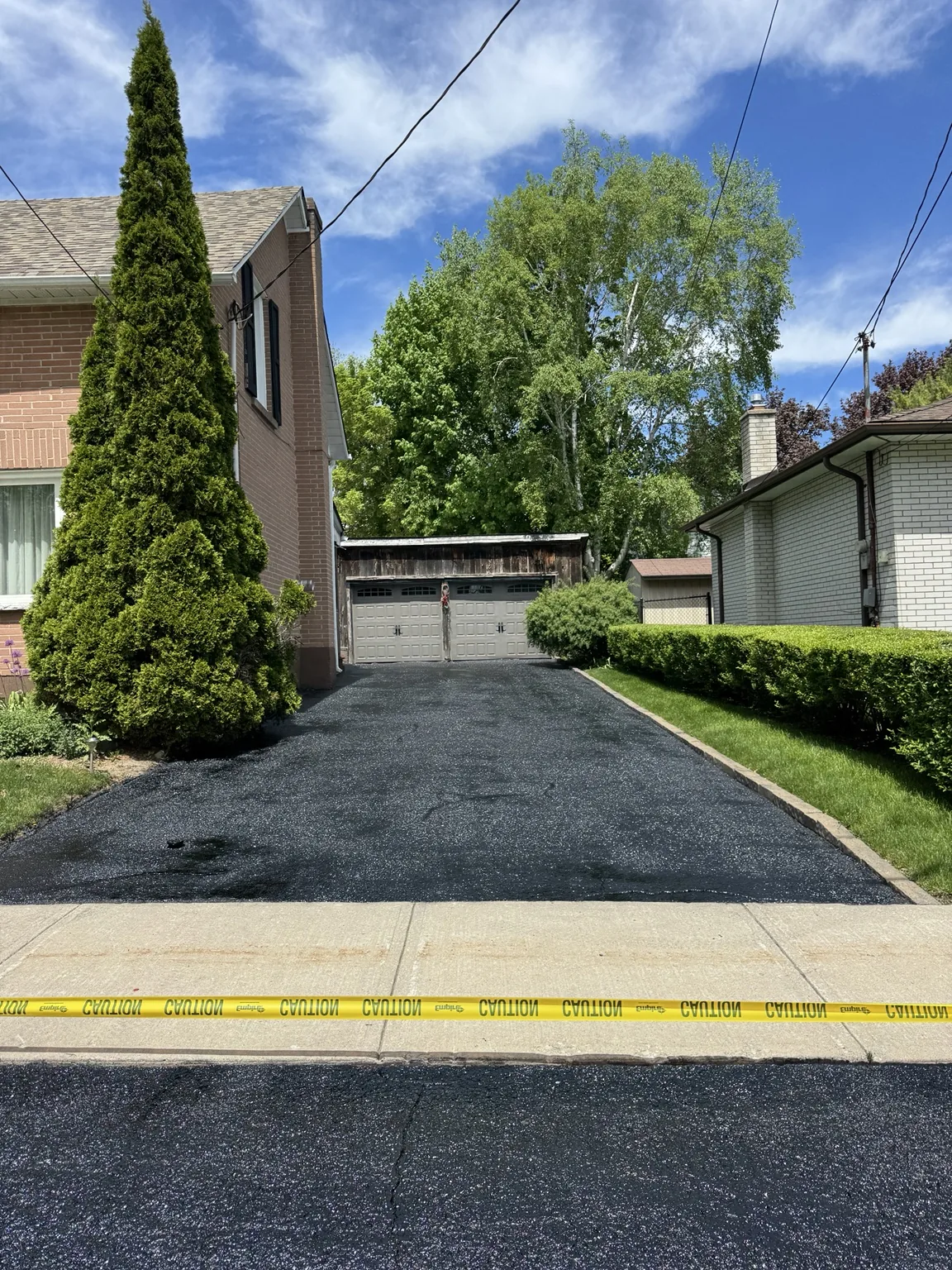 Black sealed residential driveway improving curb appeal
