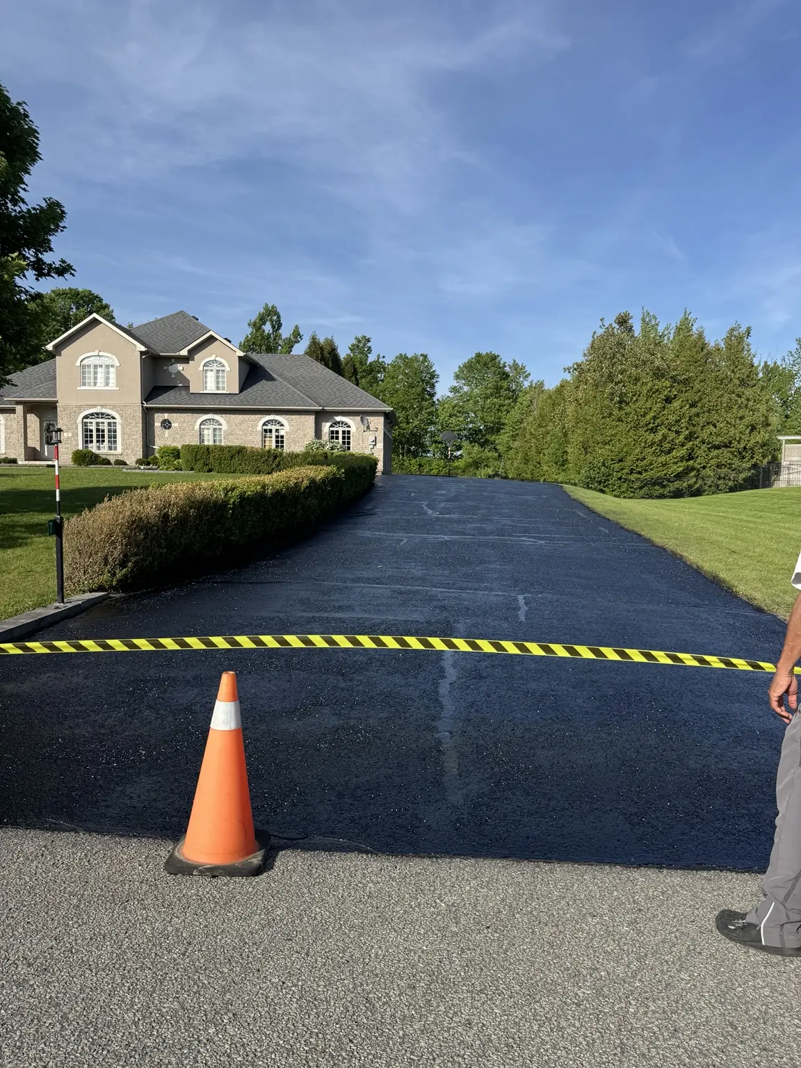 Large residential asphalt driveway after sealing